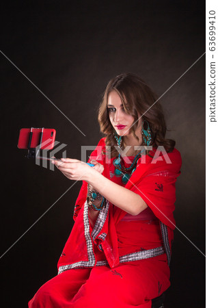 Woman in red sari 63699410