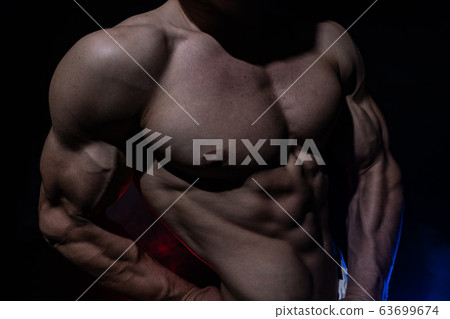 Muscular man showing muscles isolated on the black background. Concept of goal, afford, creation your self, perseverance, fortitude, focus and labor 63699674