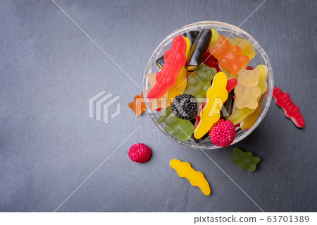 candies inside a glass cup on gray background 63701389