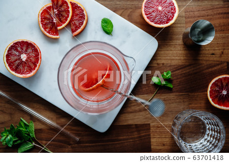 Refreshing cold summer cocktail with blood orange and mint on a marble tray.  63701418