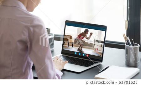 Young woman watching educational fitness training video. 63701623