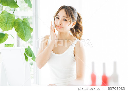 Woman doing make-up Woman doing make-up 63705083