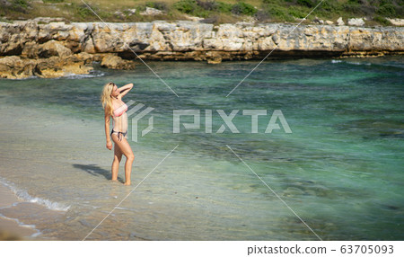 girls in a swimsuit on the beach with big breasts Stock Photo