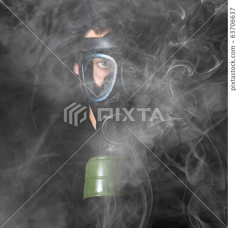 Man in a gas mask in the smoke Man in a gas mask in the smoke 63706637