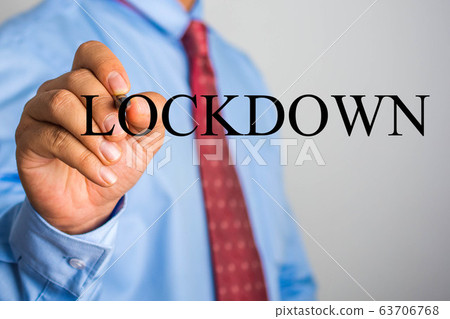 Businessman writing LOCKDOWN on virtual screen 63706768