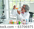 Senior male supervisor doing experiments and 63706975