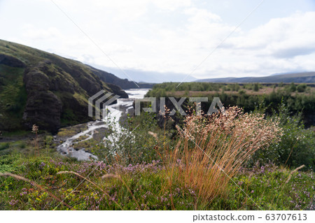 view of valley with braun grass foreground , blurred view of valley with braun grass foreground , blurred 63707613