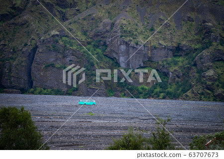 Iceland mountain view with 4x4 big bus. Waiting for tourists 63707673