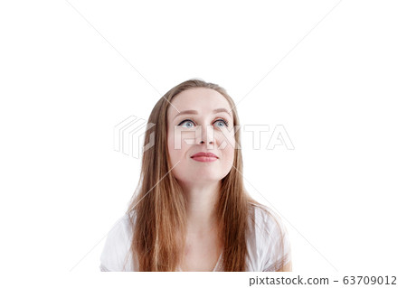 Close-up headshot of young natural pensive woman 63709012