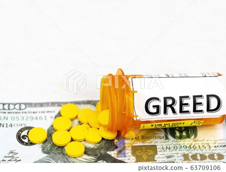 Yellow pills spill on one hundred dollar bill from Yellow pills spill on one hundred dollar bill from 63709106