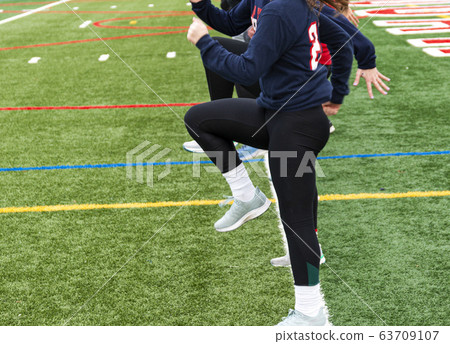 Girls track team in a line standing in A-Position Girls track team in a line standing in A-Position 63709107