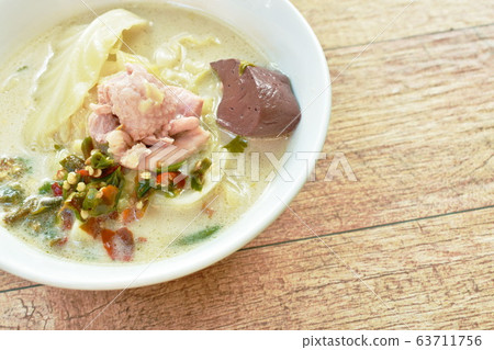spicy boiled chicken meat and blood with slice cabbage in coconut milk soup on bowl 63711756