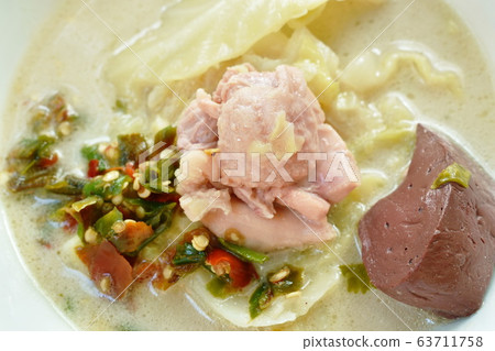 spicy boiled chicken meat and blood with slice cabbage in coconut milk soup on bowl 63711758