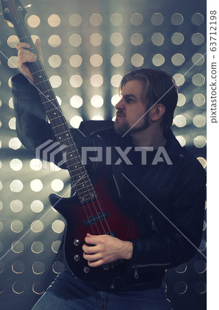 Bassist playing bass guitar in smoke. backlight Bassist playing bass guitar in smoke. backlight 63712198