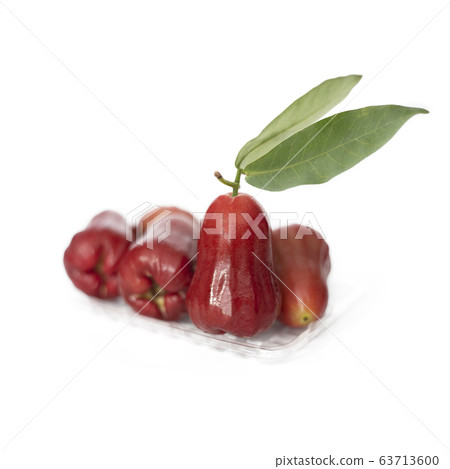 Ripe red rose apple fruit over transparent tray Ripe red rose apple fruit over transparent tray 63713600