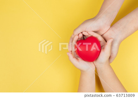 world health day, adult and child hands holding red heart, healthcare, love and family insurance 63713809