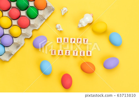 Easter day little Bunny rabbit with decorated eggs on yellow background 63713810