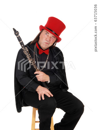 A clarinet player with a red hat and black outfit 63715036