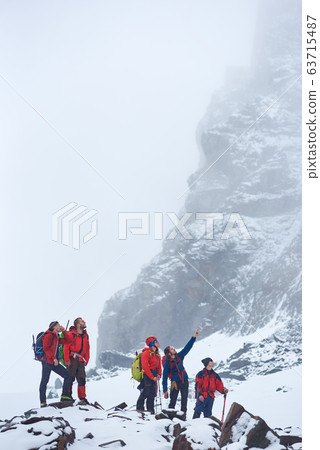 Group of mountaineers preparing to climb the mountain. Group of mountaineers preparing to climb the mountain. 63715487