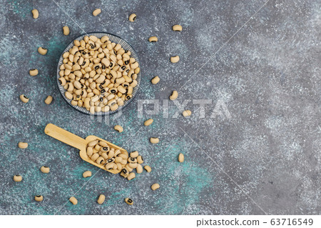 Legumes and beans assortment in different bowls on light stone background . Top view. Healthy vegan protein food. 63716549