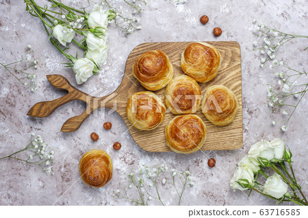 Azerbaijan national pastry qogal on white plate on light background ,top view,spring new year celebration Novruz holiday. Azerbaijan national pastry qogal on white plate on light background ,top view,spring new year celebration Novruz holiday. 63716585