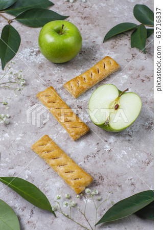 Apple puff pastry cookies in apple shape plate with fresh apples ,top view Apple puff pastry cookies in apple shape plate with fresh apples ,top view 63716837