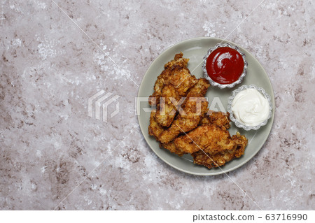 Chicken strips with ketchup and mayonnaise. top view on brown light background. 63716990