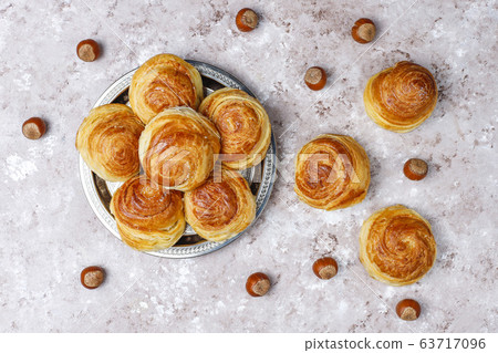 Azerbaijan national pastry qogal on white plate on light background ,top view,spring new year celebration Novruz holiday. 63717096