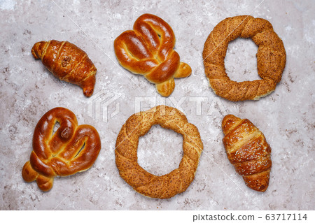 Various sweet buns on brown concrete background,top view 63717114