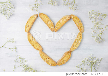 Italian tuscan traditional cookies cantuccini with almonds ,a cup of coffee on light background,top view Italian tuscan traditional cookies cantuccini with almonds ,a cup of coffee on light background,top view 63717119
