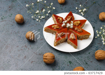 Azerbaijan national pastry pakhlava on white plate on dark background ,top view,spring new year celebration Novruz holiday. 63717429