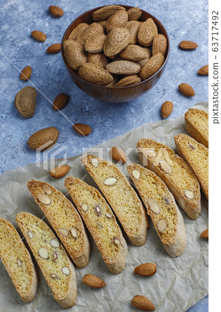 Italian tuscan traditional cookies cantuccini with almonds on grey concrete background,top view Italian tuscan traditional cookies cantuccini with almonds on grey concrete background,top view 63717492