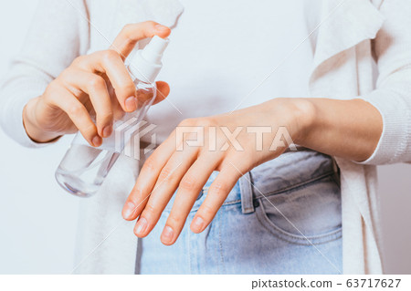 Female hands applying antibacterial disinfectant Female hands applying antibacterial disinfectant 63717627