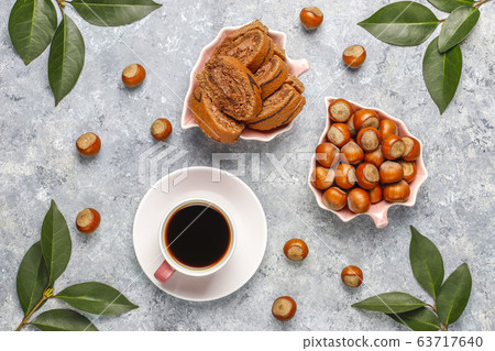 Delicious sweet chocolate cake roll with hazelnut cream and hazelnuts,top view 63717640