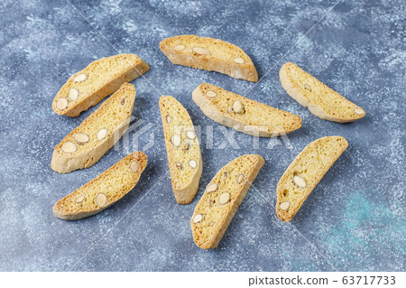 Italian tuscan traditional cookies cantuccini with almonds on grey concrete background,top view Italian tuscan traditional cookies cantuccini with almonds on grey concrete background,top view 63717733