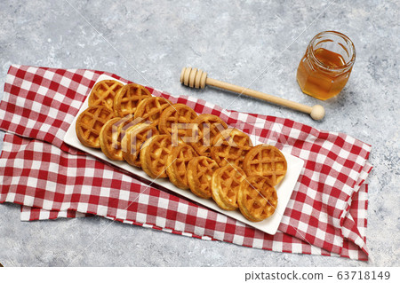Homemade Mini waffles on grey concrete background Homemade Mini waffles on grey concrete background 63718149