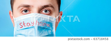 Portrait of young man in protective mask with Stay 63718458