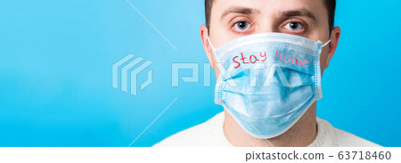 Portrait of young man wearing medical mask with Portrait of young man wearing medical mask with 63718460