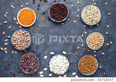 Legumes and beans assortment in different bowls on light stone background . Top view. Healthy vegan protein food. 63718547