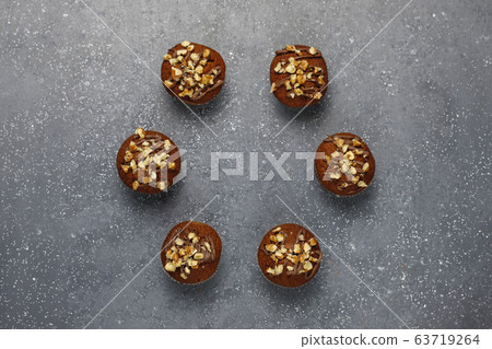 Chocolate-walnut muffins with coffee cup with walnuts on dark background ,Selective Focus. Chocolate-walnut muffins with coffee cup with walnuts on dark background ,Selective Focus. 63719264