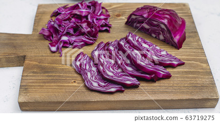 Process of cooking slicing food fresh vitamin salad from red cabbage on cutting board,top view 63719275