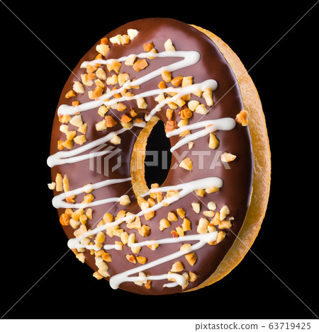 Glazed chocolate donut with nuts on a black Glazed chocolate donut with nuts on a black 63719425
