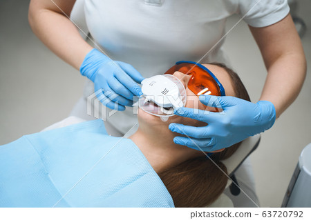 Woman with dental gadget in mouth stock photo Woman with dental gadget in mouth stock photo 63720792