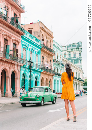 Tourist girls in popular area in Havana, Cuba. Young woman traveler smiling 63720962