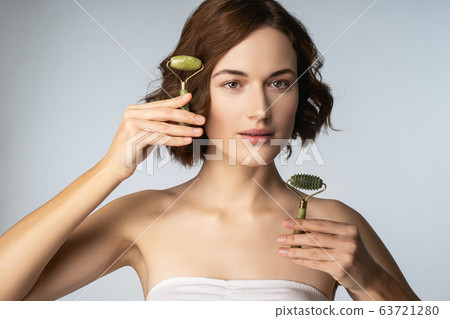 Beautiful brunette girl looking straight at camera Beautiful brunette girl looking straight at camera 63721280