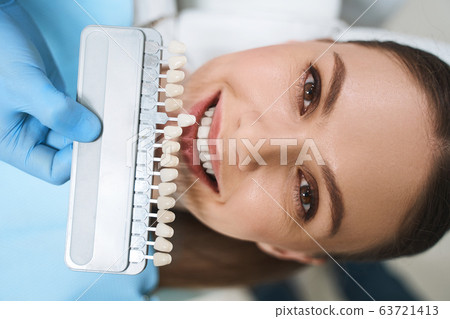 Smiling woman is choosing veneers stock photo 63721413