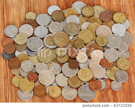 Various coins of different countries of world on wooden background. Various coins of different countries of world on wooden background. 63722056