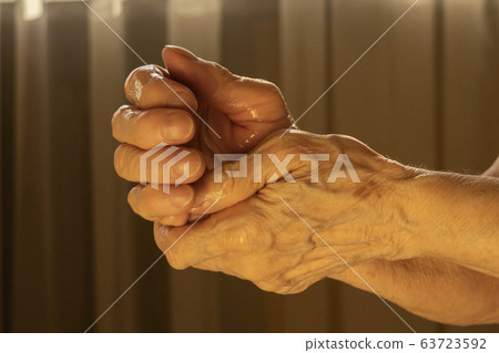 Older caucasian woman applying alcohol gel Older caucasian woman applying alcohol gel 63723592