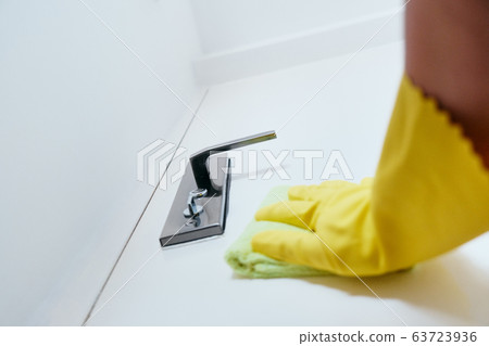 Person With Gloves Disinfecting Door Knob Using Sanitizer 63723936
