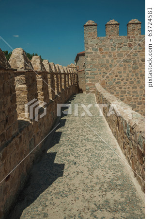 Pathway over thick stone wall with battlement in Avila Pathway over thick stone wall with battlement in Avila 63724581